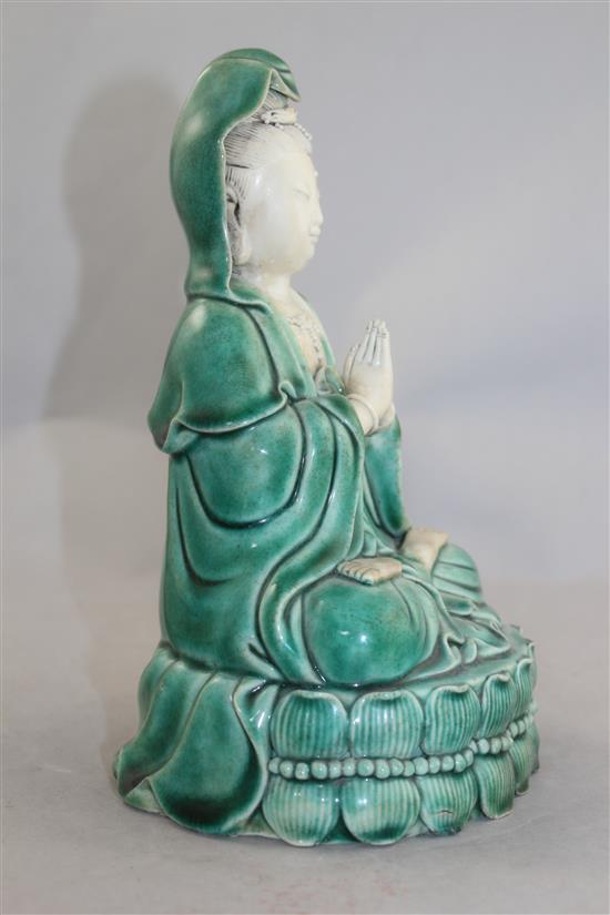 A Chinese green glazed biscuit porcelain seated figure of Guanyin, 12cm